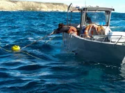 Nicole Bichard pulling up a bag of Abalone.