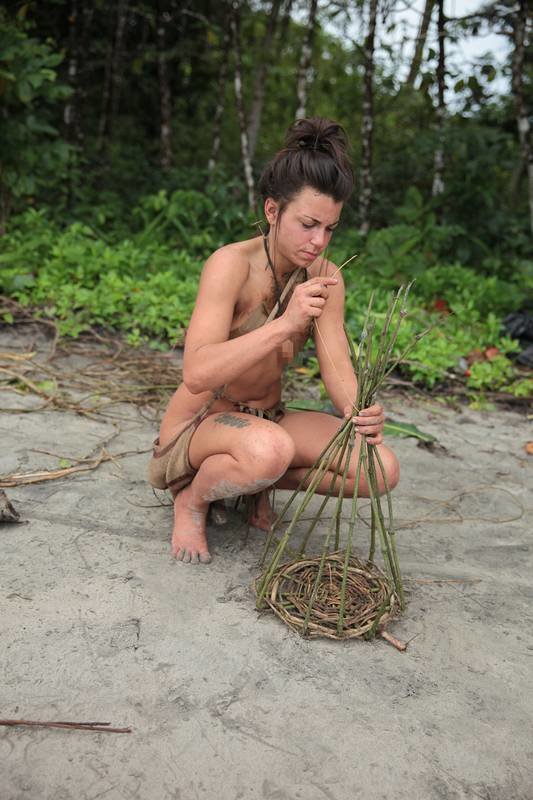 Laura using leaves to build necessary equipment for her and Clint.