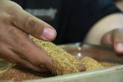 Close-up of Mike Beets hand touching the gold.
