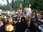 Couple Erica Susy Kelley and Anthony Tony Swift pass food to their guests at their bohemian reception