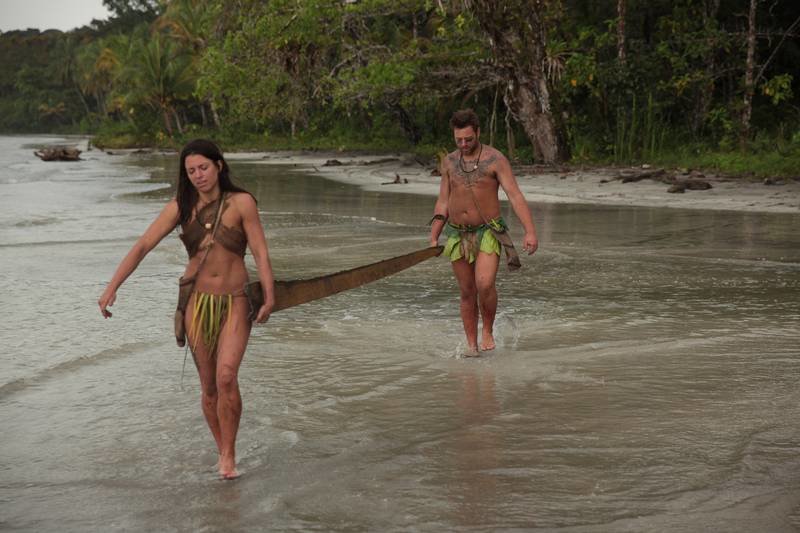 Clint and Laura carrying wood back to their shelter.